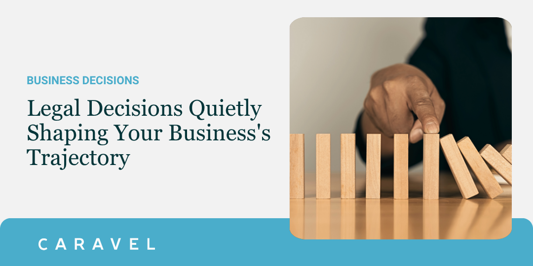 Hand stopping dominos from tipping